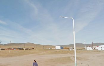 Photo of desert town overlaid with a digital representation of a person carrying a shopping bag