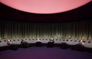 Several people reclined in chairs taking part in the Dreamachine live experience