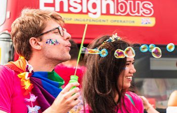 Two people blowing bubbles at Brighton and Hove Pride 2018