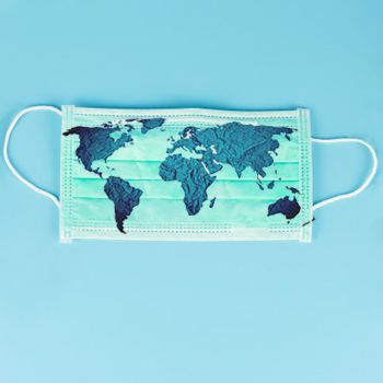 A surgical facemask on a blue background with a map of different countries on top of the mask