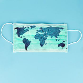 A surgical facemask on a blue background with a map of different countries on top of the mask