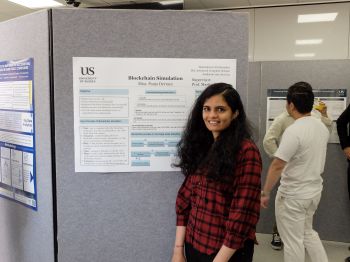 An MSc student shows off their poster