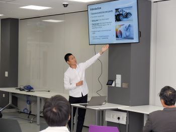 A PhD student presents their research in the Future Technologies lab to an audience.