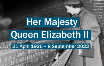 Black and white photo of the Queen revealing a plaque with text: Her Majesty Queen Elizabeth II 21 Apr 1926-8 Sept 2022
