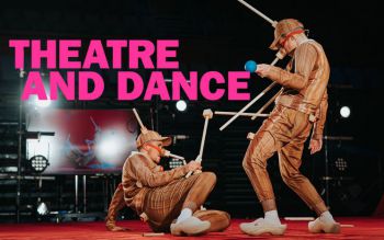 Two actors performing at the ACCA, one of them lying on the floor while the other stands next to him. The text reads 