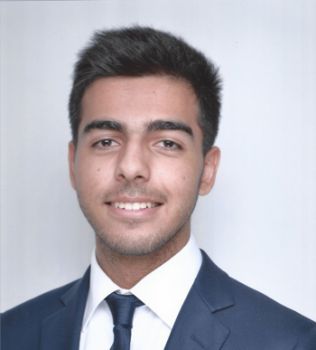 Portrait photograph of Business School graduate Husain Alogaily. Winner of the Global Peer-Leader Award