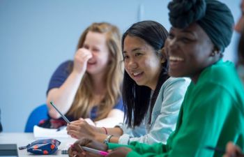 Students smiling in a seminar room