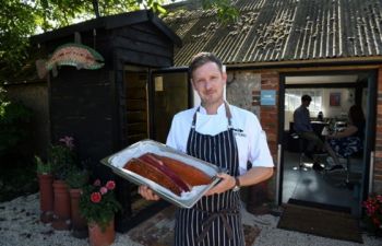 Michael King - Executive Chef Holding Smoked Fish