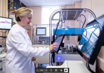 Dr Sarah Lilley looking at lab equipment