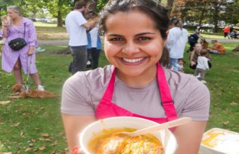 Woman holding box of potato chaat street food