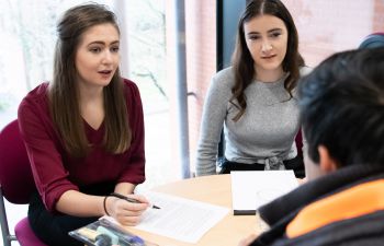 University of Sussex law students helping a client during a law clinic