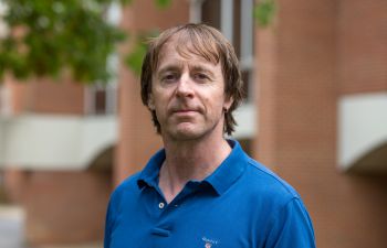 headshot of Professor John Drury