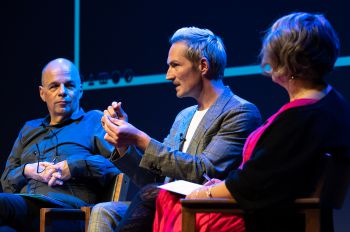 Musician Dan Gillespie Sells speaks on the Attenborough Centre stage. David Ruebain and Sharon Webb listen