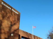 Disability flag flying over Sussex House building