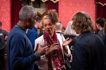 A close up of 3 supporters enjoying a conversation