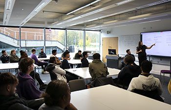 Students in the seminar room watching the speakers at the Fintech Coffee Connect event