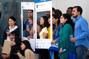 Student award winners hold up certificate frames and pose for a group picture