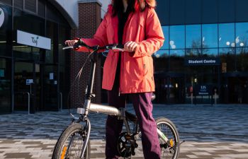 An image of the bike winner, stood with their bike.