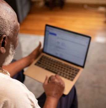 Older man pictured using a laptop