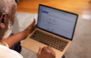 Older man pictured using a laptop