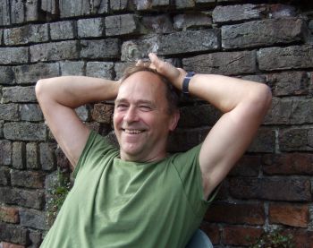 Sussex alumnus Laurence Benson leaning back relaxed against a wall