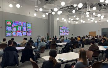 Student attending a presentation in the large conference room at the Student Centre