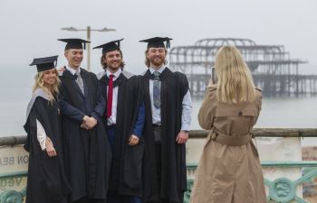 Students capturing moment from Winter Graduation along Brighton seafront
