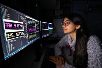 Dr Mariam Akhtar at the control panel of a quantum computer at the University of Sussex