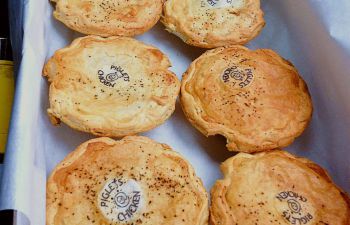 Six bakery pies lined up