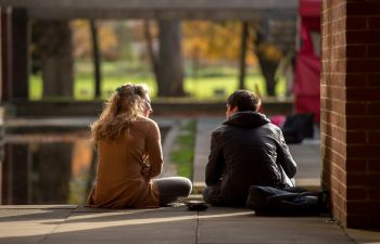 Two postgraduates sitting and talking