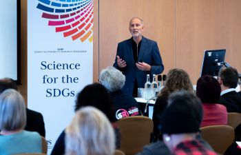 Joe Alcamo giving a presentation on delivering science for the Sustainable Development Goals. He is pictured standing in front of an audience