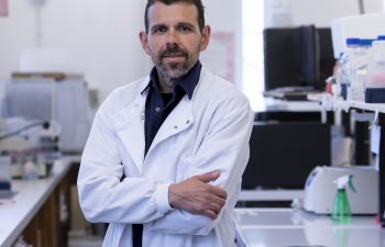 Georgios Giamas, Professor of Cancer Cell Signalling in his lab wearing his lab coat