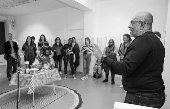 Michael McMillan speaking to a group of people in an art gallery