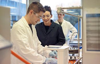 Three technicians working in a laboratory