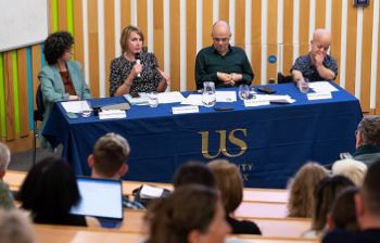 Hadeer Elshafie, Hannah Mason-Bish, David Ruebain and Tom Shakespeare seated behind a panel desk