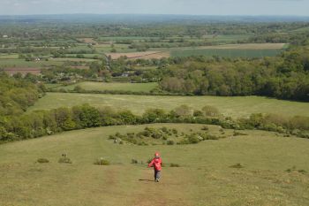 A child running across the South Downs and into a Sussex landscape