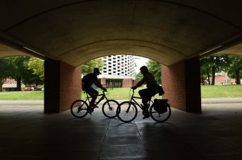 Two cyclists passing each other near to the meeting house