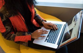 Lady typing on a laptop