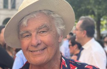 Rod Bond smiling and looking relaxed and happy with a straw hat on