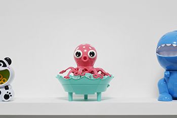 A group of toys in the collection of a public library In the centre there is a pink octopus.