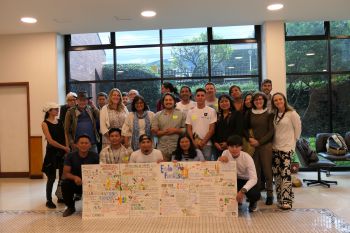 A group of participants showing illustrations that summarise the discussions.