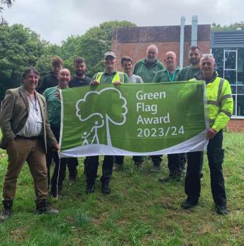 A photo of the SEF Grounds team holding the Green Flag award flag