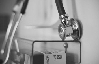 A black and white image of a stethoscope close up on a box