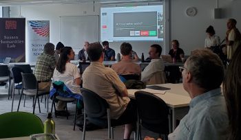 Participants sitting and listening to the speakers during the lightening talk part of the research networking workshop