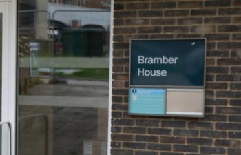 brick building with a blue sign reading 'Bramber House'