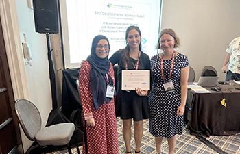 Left to right -  Dr Ghazal Zulfiqar, Belinda Zakrzewska and Dr Alexandra Bristow standing with Best Development Reviewer certificate