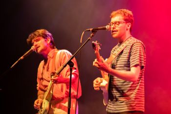 Image of Sam playing guitar on stage