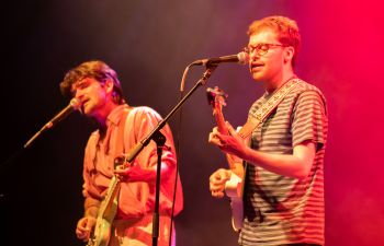 Image of Sam playing guitar on stage