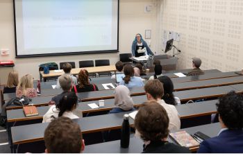 Alt-text Photograph from the conference: Lucy Robinson welcomes delegates with an opening presentation