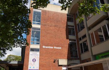 red brick building with a sign reading Bramber House